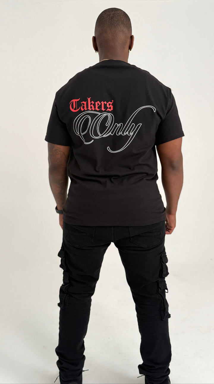 Person wearing a black t-shirt with 'Takers Only' text on the back, standing against a white background